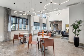 Dining room with tables and chairs and a large window at The Virginia, Seguin, Texas